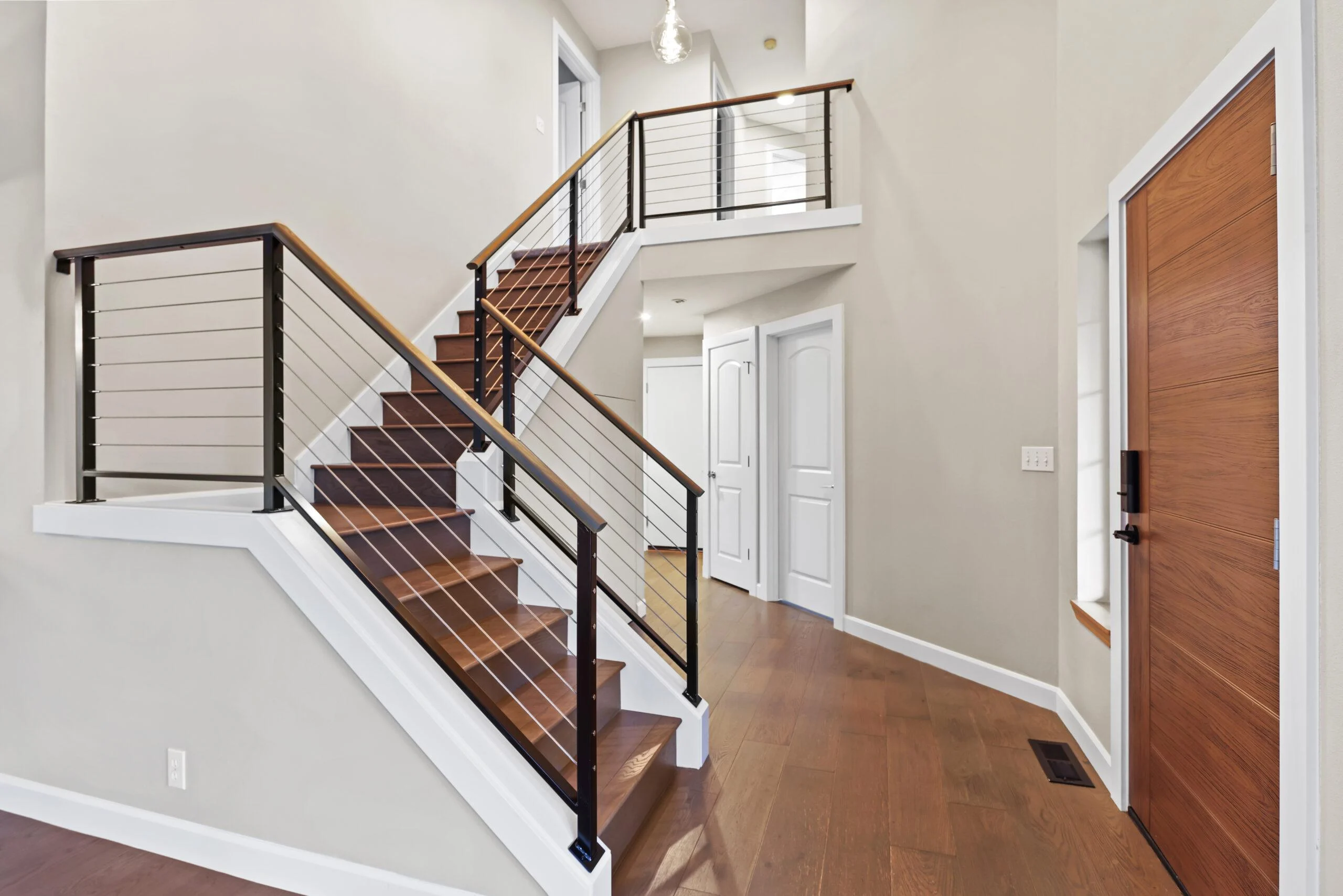 Total home transformation — custom kitchen, flooring, cable railings, quartz fireplace Kirkland, WA